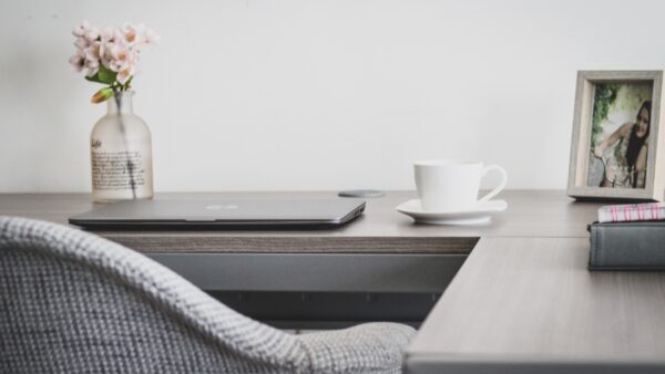 A home office desk with a laptop set up for remote work