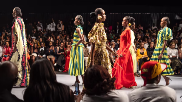 Models showcase colourful African-inspired designs on a runway during a fashion show in Lagos.