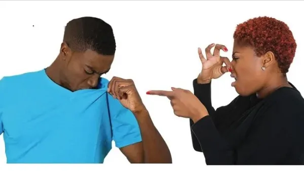 Man and Woman covering her nose because of an unpleasant body odour.