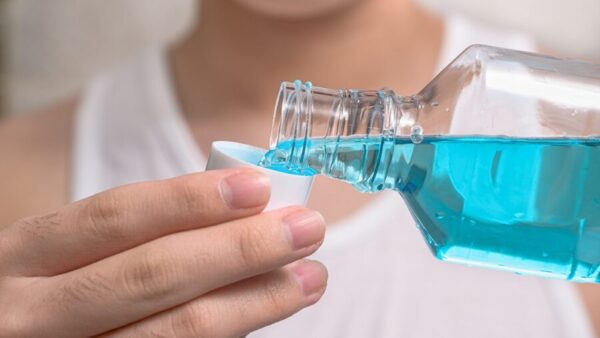 A clear blue liquid poured into a small cup