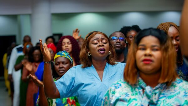 A group of people with hands raised in worship