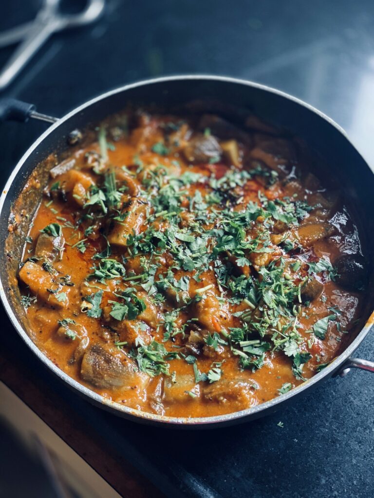 Cooked food in a black cooking pot