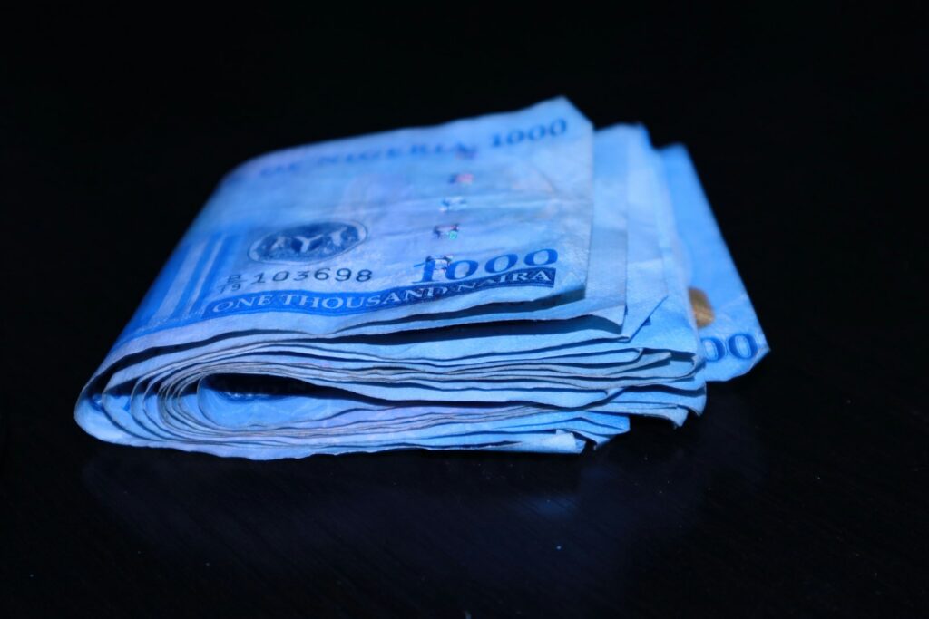 A stack of folded naira notes on a table